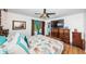Main bedroom with king-size bed, wood floors, and access to the pool at 13191 92Nd Ave, Seminole, FL 33776