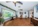 Bright living room with bay window, tile floors, and ceiling fan at 13191 92Nd Ave, Seminole, FL 33776
