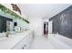 Modern bathroom with double vanity and a walk-in shower at 13191 92Nd Ave, Seminole, FL 33776