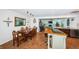 Elegant dining room with wood table and chairs, and open view to kitchen at 13191 92Nd Ave, Seminole, FL 33776