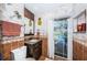 Small bathroom with granite vanity, tiled floors, and access to backyard pool at 13191 92Nd Ave, Seminole, FL 33776