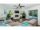 Relaxing living room with a fireplace and pool view at 13191 92Nd Ave, Seminole, FL 33776