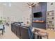 Spacious living room featuring tile floors, blue accent wall, built-in shelving, and vaulted ceilings at 1342 Salmonberry St, Wesley Chapel, FL 33543