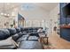 Open concept living space with dark kitchen cabinets, a huge sectional, and lots of natural light at 1342 Salmonberry St, Wesley Chapel, FL 33543