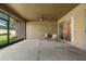 A covered patio with seating and a ceiling fan at 1342 Salmonberry St, Wesley Chapel, FL 33543