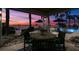 Waterfront patio with seating and sunset view at 1828 Venetian Point Dr, Clearwater, FL 33755