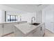 Modern kitchen with a large marble island and water views at 2912 W Santiago St # 1901, Tampa, FL 33629