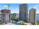 Aerial view showcasing building exterior, pool, tennis court, and surrounding cityscape at 2912 W Santiago St # 1901, Tampa, FL 33629