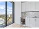 Modern wet bar with wine cooler and marble countertop at 2912 W Santiago St # 1901, Tampa, FL 33629