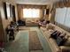 Living room with beige couches, patterned rugs and wood paneled walls at 3002 E Elm St, Tampa, FL 33610