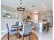 Kitchen dining area with a farmhouse table and chandelier at 9612 Little Bluestem Dr, Land O Lakes, FL 34637