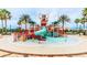Community waterpark with slides, sprinklers, and shaded seating at 9612 Little Bluestem Dr, Land O Lakes, FL 34637