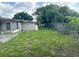 Long side yard with a large grassy area and privacy fence at 308 Ravenna St, Nokomis, FL 34275