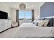Main bedroom with water view and large windows, dressed with stylish bedding at 31873 Anchor Point Dr, Wesley Chapel, FL 33545