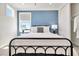 Bedroom with a metal bed frame and a view from the window at 31873 Anchor Point Dr, Wesley Chapel, FL 33545