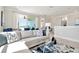 Open-concept living area with sectional sofa, offering views of the balcony at 31873 Anchor Point Dr, Wesley Chapel, FL 33545