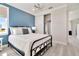 Bedroom with a metal bed frame, blue accent wall and closet at 31873 Anchor Point Dr, Wesley Chapel, FL 33545