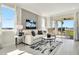 Spacious living room with large windows, comfortable seating, and water views at 31873 Anchor Point Dr, Wesley Chapel, FL 33545