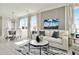 Spacious living room with large windows, comfortable seating, and water views at 31873 Anchor Point Dr, Wesley Chapel, FL 33545