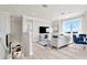 Light and airy living space with a view of the kitchen and stairs at 31873 Anchor Point Dr, Wesley Chapel, FL 33545