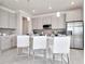 Modern kitchen with stainless steel appliances and an island with seating at 31873 Anchor Point Dr, Wesley Chapel, FL 33545