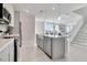 Modern kitchen with island, stainless steel appliances, and white cabinets at 31873 Anchor Point Dr, Wesley Chapel, FL 33545