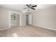 Bright bedroom with mirrored closet doors and wood-look flooring at 5838 Wyoming Ave, New Port Richey, FL 34652