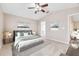 Main bedroom with gray bedding and en-suite bathroom access at 6340 Sushi Ct, Wesley Chapel, FL 33545