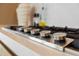 Close up of a modern gas cooktop with stainless steel knobs at 1000 Water St # 1103, Tampa, FL 33602
