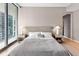 Modern bedroom with a neutral color palette and city views at 1000 Water St # 1103, Tampa, FL 33602