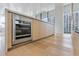 Sleek stainless steel wine cooler built into light wood cabinetry at 1000 Water St # 1103, Tampa, FL 33602