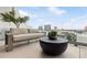 Relaxing balcony overlooking the cityscape, featuring a sofa and coffee table at 1000 Water St # 1103, Tampa, FL 33602