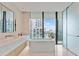 Modern bathroom with freestanding tub and city views at 1000 Water St # 1103, Tampa, FL 33602