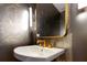 Modern bathroom with gold fixtures and patterned wallpaper at 1000 Water St # 1103, Tampa, FL 33602