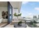 Outdoor balcony with city and stadium views, includes a sofa and small table at 1000 Water St # 1103, Tampa, FL 33602
