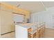 Contemporary kitchen featuring a marble island and light wood cabinetry at 1000 Water St # 1103, Tampa, FL 33602