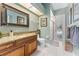 Elegant bathroom with granite vanity, large mirror, and walk-in shower at 10412 Carroll Cove Pl, Tampa, FL 33612