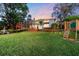 Large backyard with a playground and deck at 10412 Carroll Cove Pl, Tampa, FL 33612