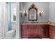 Bathroom with granite countertop and dark wood cabinets at 10412 Carroll Cove Pl, Tampa, FL 33612