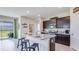 Modern kitchen featuring granite countertops and dark cabinetry at 18217 Beach Ranch Ter, Lakewood Ranch, FL 34211