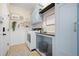 Bright laundry room with built-in cabinetry and shelving at 32746 Coldwater Creek Loop, Wesley Chapel, FL 33545