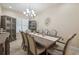 Bright dining room showcases a decorative light fixture, neutral tones, and seating for eight at 2632 Tarragona Way, Wesley Chapel, FL 33543