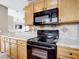Modern kitchen with black appliances and granite countertops at 7518 Lyncrest St, North Port, FL 34287