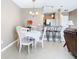 Charming dining area with a round table, four chairs, and a view of the kitchen at 7518 Lyncrest St, North Port, FL 34287