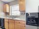 Kitchen boasts wood cabinets, granite countertops and a double sink at 7518 Lyncrest St, North Port, FL 34287