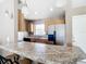 Kitchen features granite countertops, wood cabinets, and stainless steel appliances at 7518 Lyncrest St, North Port, FL 34287
