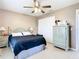 Comfortable bedroom with a queen bed, nightstands and a ceiling fan at 7518 Lyncrest St, North Port, FL 34287