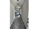 Bright hallway with light gray flooring and access to other rooms at 36164 Trinity Glade Rd, Dade City, FL 33525