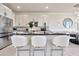White kitchen with center island and breakfast bar at 31879 Anchor Point Dr, Wesley Chapel, FL 33545