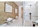 Elegant bathroom with a walk-in shower, gold accents and marble tile at 31879 Anchor Point Dr, Wesley Chapel, FL 33545